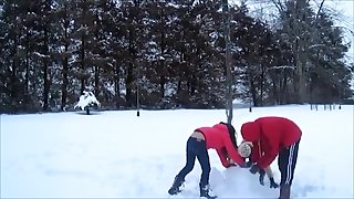 Girl in low rise jeans building snowman