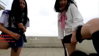two asian girls enjoy humiliating their slaves