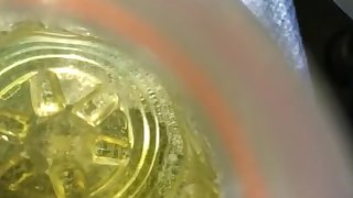 Young man pisses in a Gatorade bottle in his car